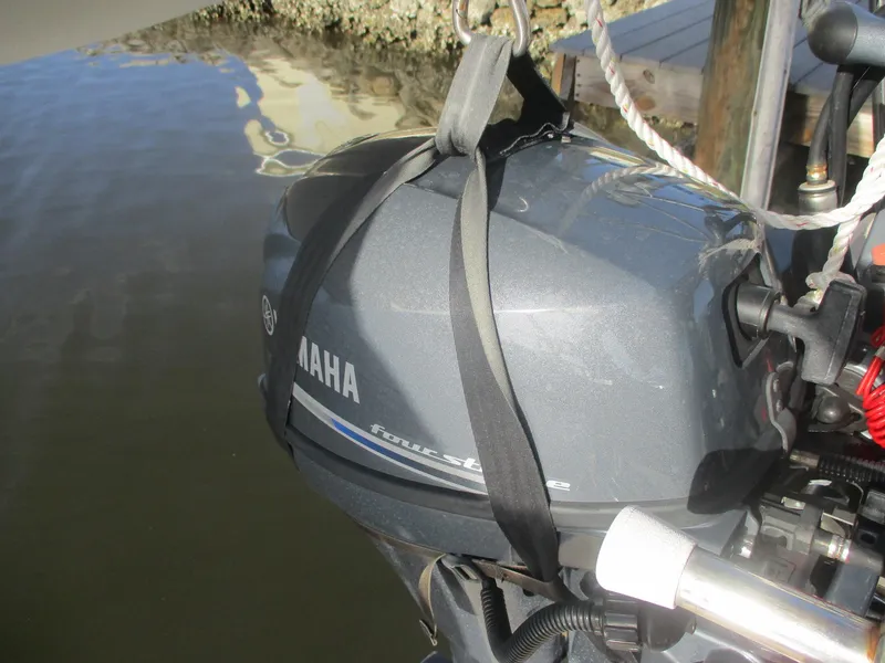 Slide: The Image of Yamaha four-stroke outboard motor on Island Packet 380, 1999 model, docked by water. - 26