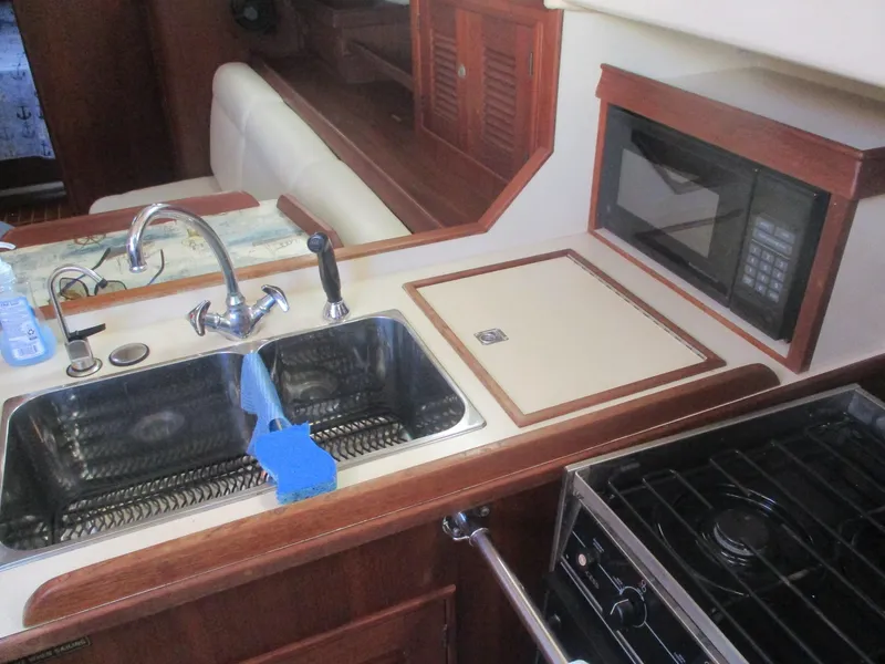 Slide: The Image of Island Packet 380 yacht kitchen with sink, stove, and microwave, 1999 model. - 37