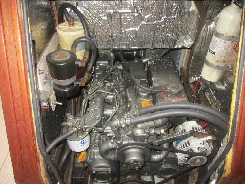 Slide: The Image of Engine compartment of a 1999 Island Packet 380 sailboat, featuring various mechanical components. - 40