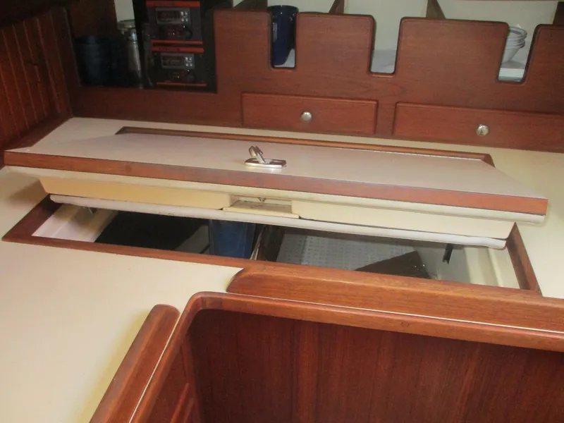 Slide: The Image of Interior of 1999 Island Packet 380 sailboat showing wooden cabinetry and storage compartments. - 41