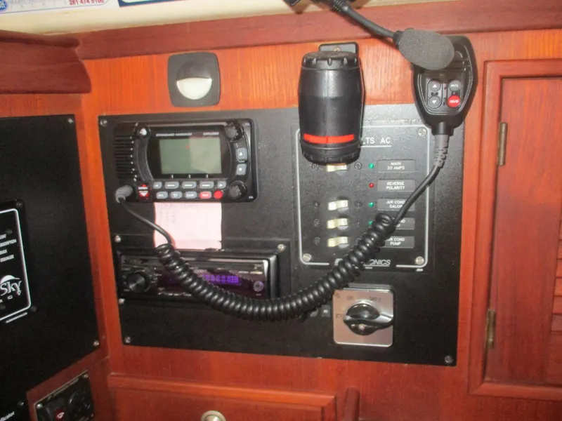 Slide: The Image of Control panel of a 1999 Island Packet 380 sailboat with radio and switches. - 47