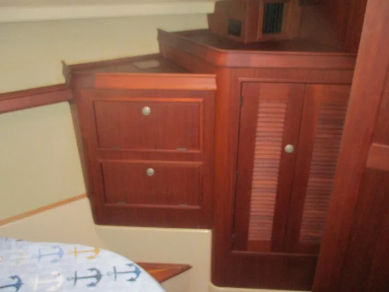 Slide: The Image of Interior of 1999 Island Packet 380 sailboat with wooden cabinetry and nautical-themed decor. - 51