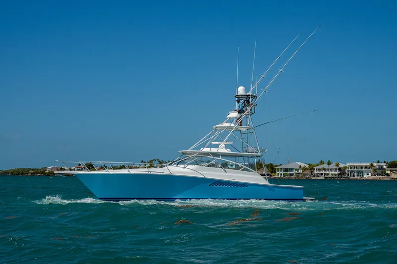 Slide: The Image of 2004 Viking Express Sport Fish boat cruising on blue ocean waters. - 0