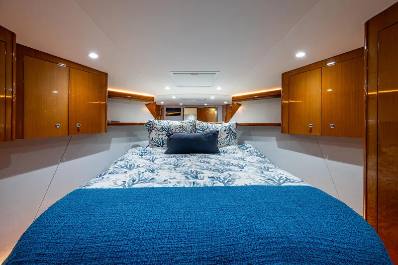 Slide: The Image of Luxurious cabin interior of 2004 Viking Express Sport Fish with elegant bedding and wood cabinetry. - 13