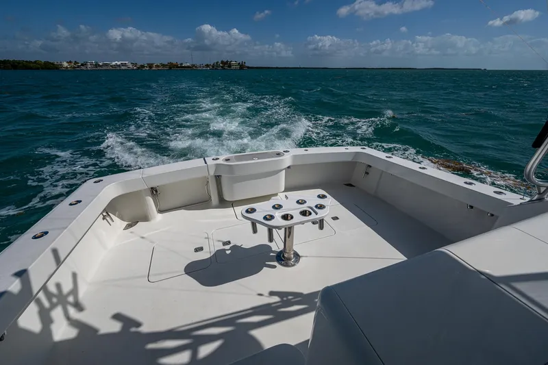 Slide: The Image of 2004 Viking Express Sport Fish boat cruising on open water under a clear sky. - 19