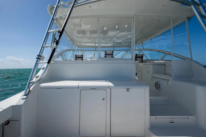 Slide: The Image of 2004 Viking Express Sport Fish boat interior with seating, ocean view, and clear skies. - 22