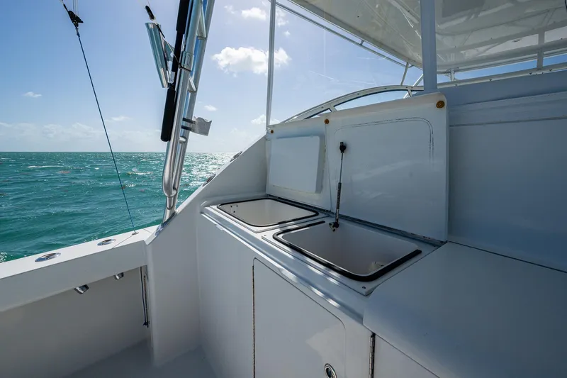 Slide: The Image of 2004 Viking Express Sport Fish boat interior with ocean view, featuring a sleek sink area. - 23
