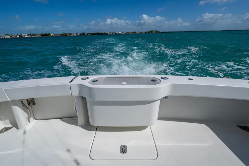Slide: The Image of 2004 Viking Express Sport Fish boat cruising on turquoise waters under a clear blue sky. - 24