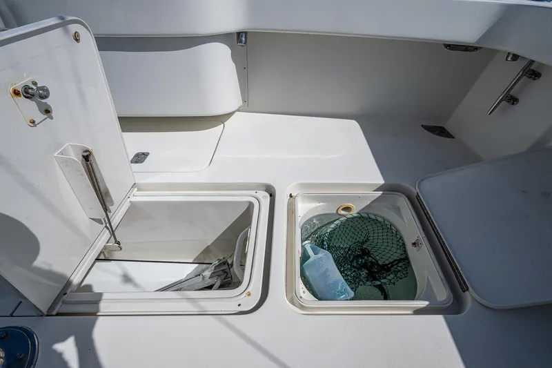 Slide: The Image of 2004 Viking Express Sport Fish boat deck with open storage compartments. - 25