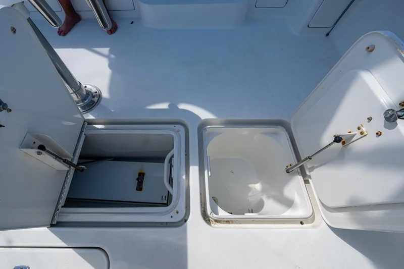 Slide: The Image of 2004 Viking Express Sport Fish boat storage compartments open on deck. - 26