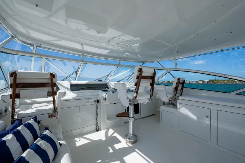 Slide: The Image of 2004 Viking Express Sport Fish yacht interior with helm chairs and panoramic windows. - 28