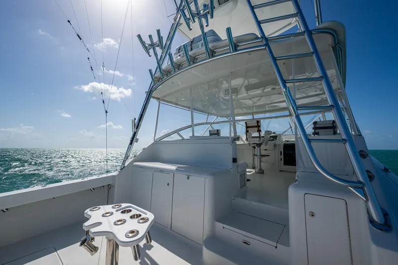 Slide: The Image of 2004 Viking Express Sport Fish yacht on open sea under clear blue sky. - 3