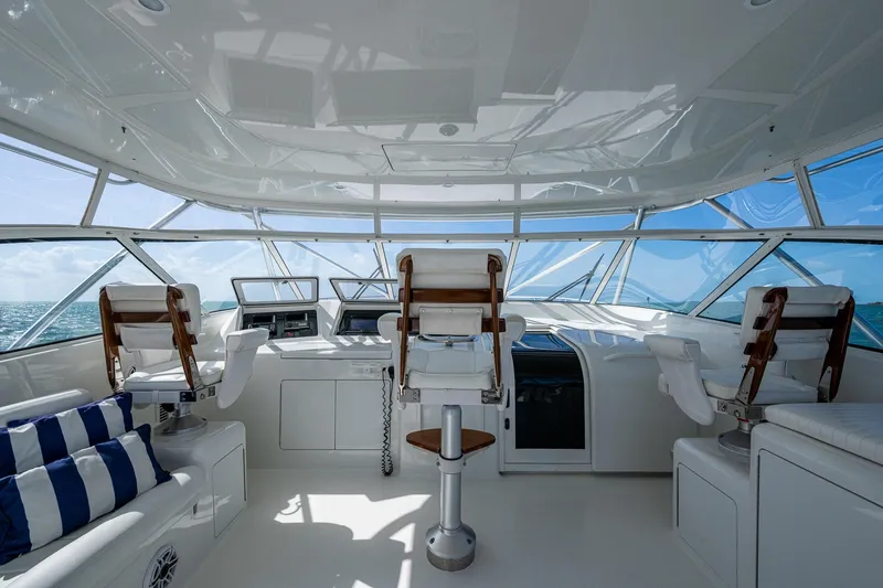 Slide: The Image of 2004 Viking Express Sport Fish yacht interior with helm, seating, and ocean view. - 30