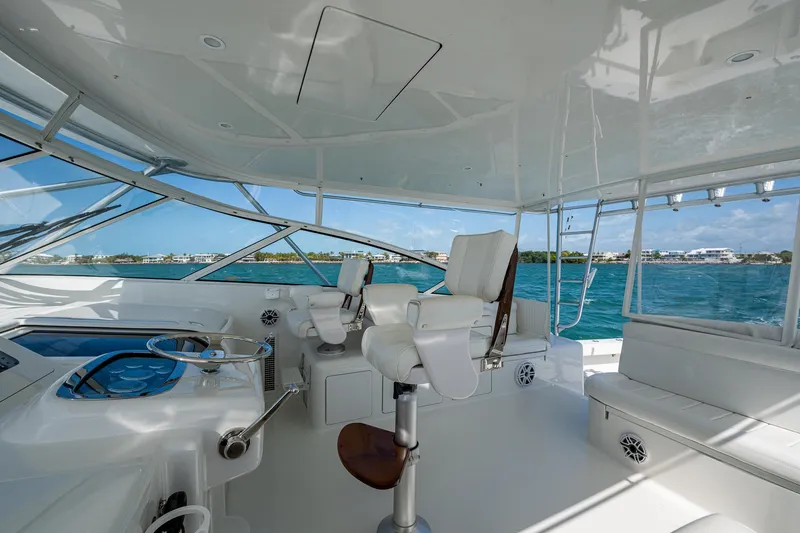 Slide: The Image of 2004 Viking Express Sport Fish yacht interior with helm, seating, and ocean view. - 31
