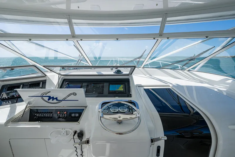 Slide: The Image of 2004 Viking Express Sport Fish helm with ocean view, featuring modern navigation equipment. - 33