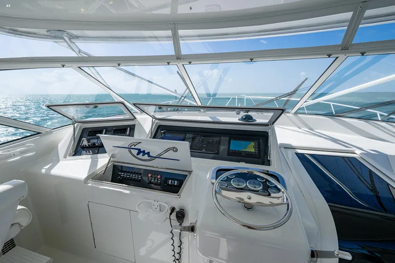 Slide: The Image of 2004 Viking Express Sport Fish helm with ocean view, featuring modern navigation equipment. - 34
