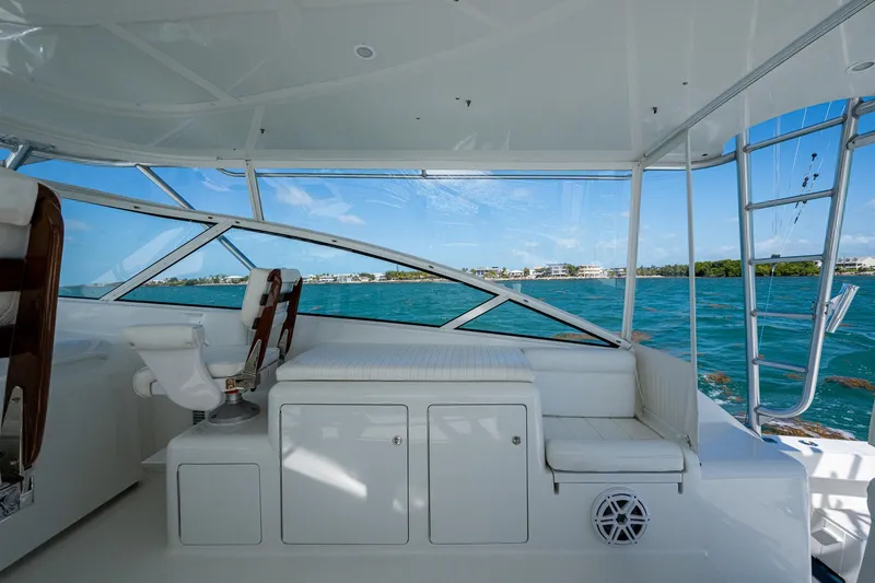 Slide: The Image of 2004 Viking Express Sport Fish interior with ocean view, featuring seating and storage. - 36