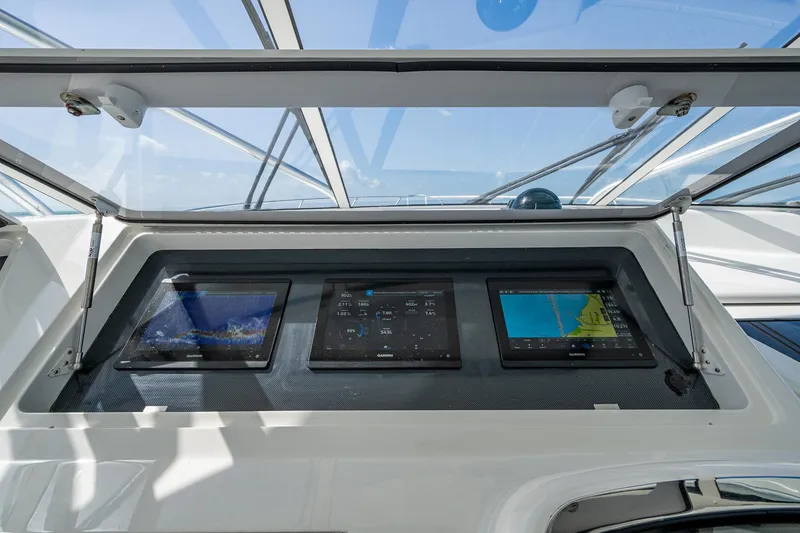 Slide: The Image of Control panel of 2004 Viking Express Sport Fish boat with navigation screens. - 37