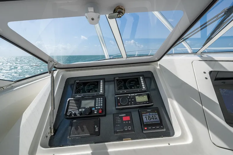 Slide: The Image of 2004 Viking Express Sport Fish dashboard with navigation instruments, ocean view through windshield. - 38