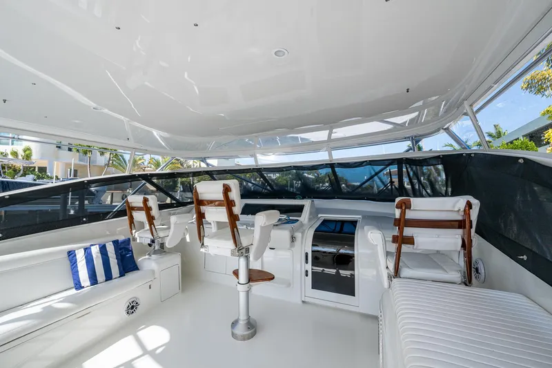 Slide: The Image of 2004 Viking Express Sport Fish yacht interior with white seating and helm station. - 4