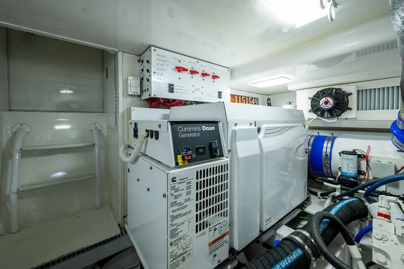 Slide: The Image of Engine room of 2004 Viking Express Sport Fish with Cummins Onan generator. - 48