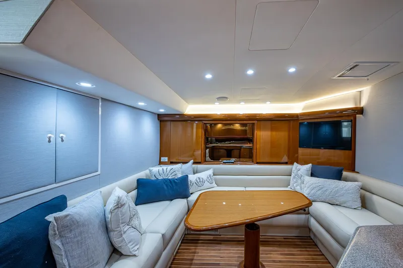 Slide: The Image of Luxurious interior of 2004 Viking Express Sport Fish yacht with plush seating and wooden accents. - 6