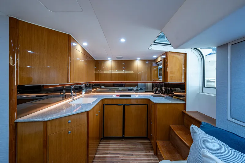 Slide: The Image of Luxurious kitchen interior of 2004 Viking Express Sport Fish yacht with wooden cabinetry. - 9