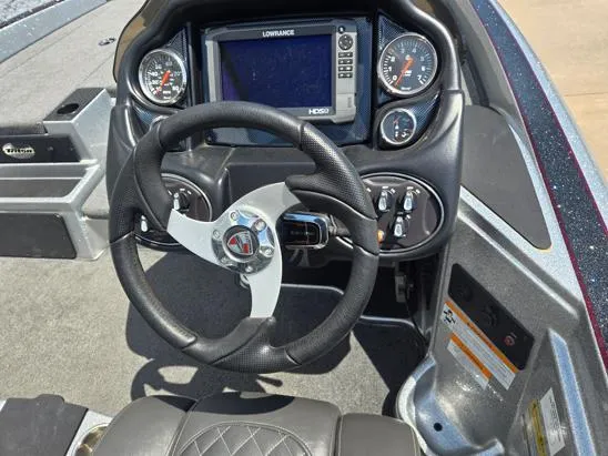 Slide: The Image of 2016 Triton 189 TRX boat dashboard with steering wheel and navigation system. - 7