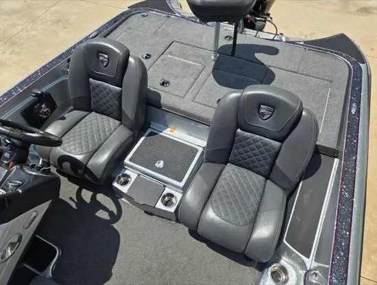 Slide: The Image of 2016 Triton 189 TRX boat interior with two black leather seats and storage compartments. - 8