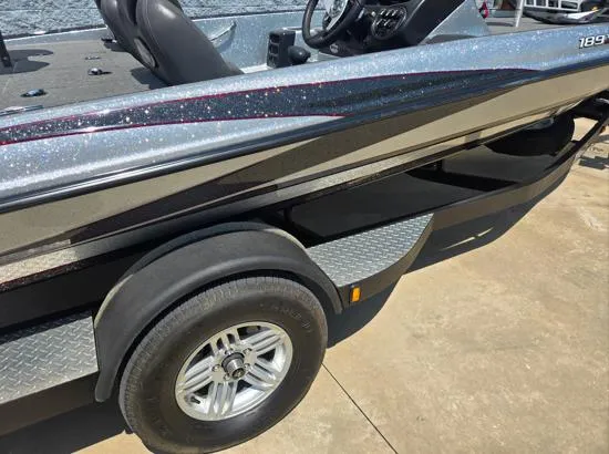 Slide: The Image of 2016 Triton 189 TRX boat on trailer, metallic finish, parked on concrete surface. - 9