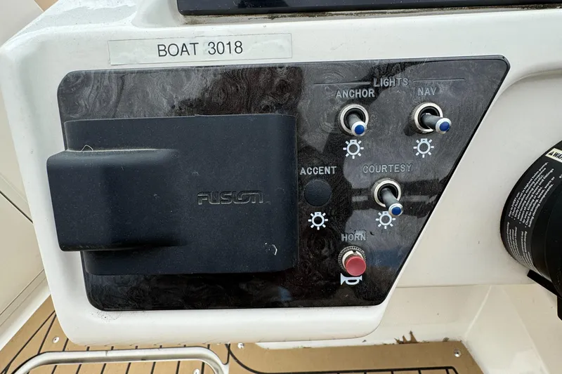 Slide: The Image of Control panel of a 2022 Sea Ray SPX 210 OB boat with labeled switches. - 12