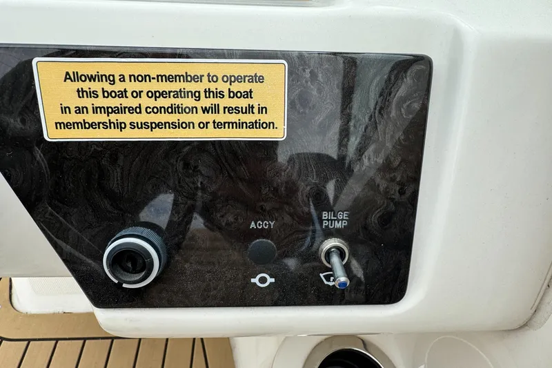 Slide: The Image of 2022 Sea Ray SPX 210 OB control panel with warning sign and bilge pump switch. - 13