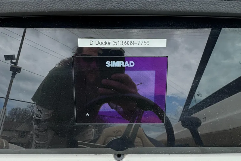 Slide: The Image of Simrad display on 2022 Sea Ray SPX 210 OB boat dashboard with dock contact info. - 14