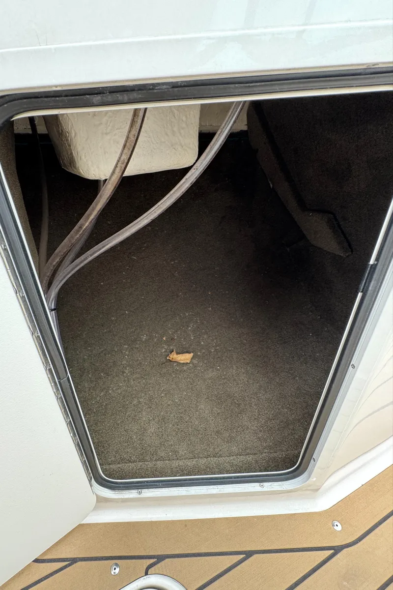 Slide: The Image of Storage compartment of 2022 Sea Ray SPX 210 OB boat, showing interior space. - 17