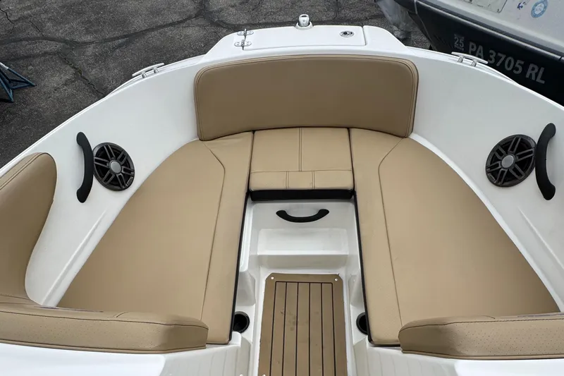 Slide: The Image of 2022 Sea Ray SPX 210 OB boat interior with tan seating and speakers. - 18