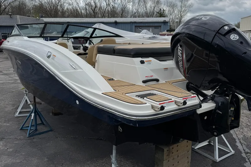 Slide: The Image of 2022 Sea Ray SPX 210 OB boat with outboard motor, displayed on stands. - 2