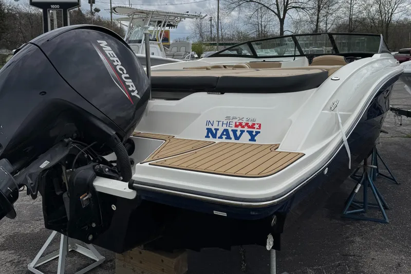 Slide: The Image of 2022 Sea Ray SPX 210 OB boat with Mercury outboard motor, docked outdoors. - 3