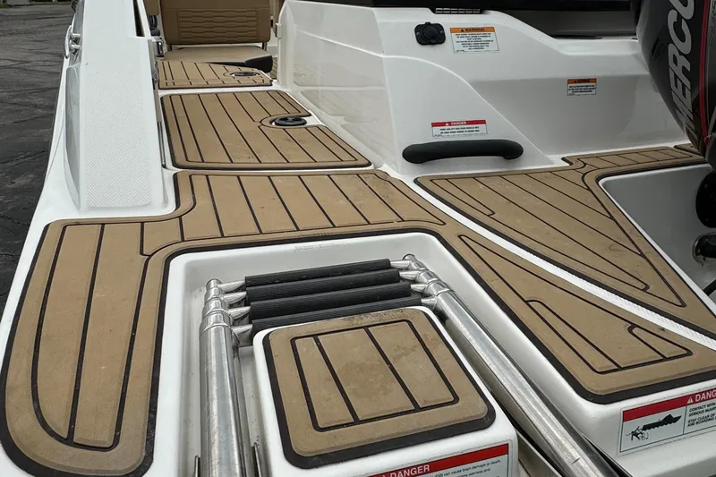 Slide: The Image of 2022 Sea Ray SPX 210 OB boat deck with wood-style flooring and ladder. - 5
