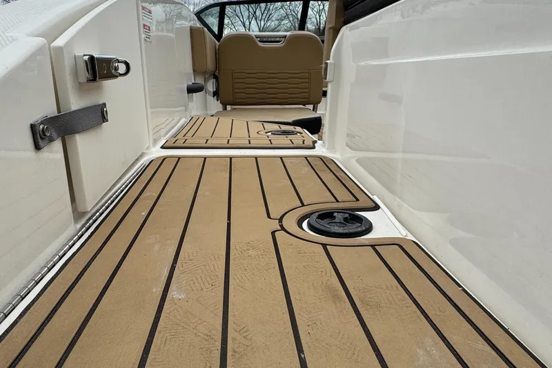 Slide: The Image of 2022 Sea Ray SPX 210 OB boat interior with tan decking and seating. - 6