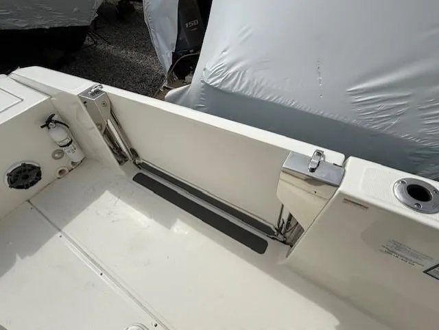 Slide: The Image of 2023 Boston Whaler 280 Dauntless boat interior, featuring a clean deck and storage compartment. - 12