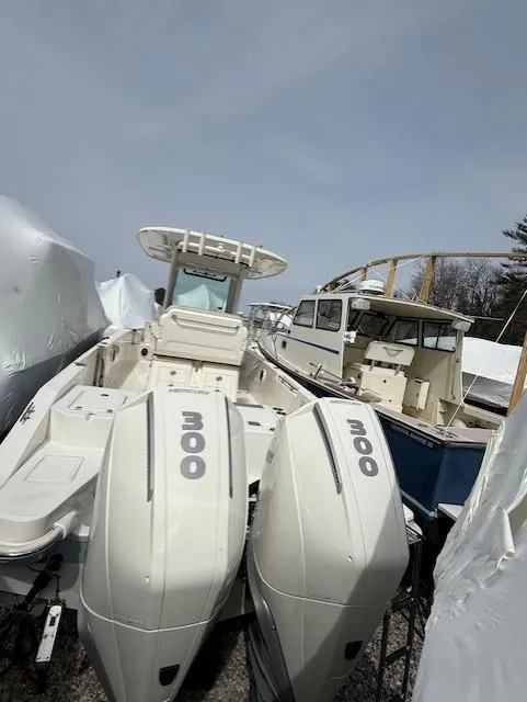 Slide: The Image of 2023 Boston Whaler 280 Dauntless boat with twin 300 engines, docked outdoors. - 15