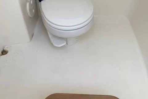 Slide: The Image of 2023 Boston Whaler 280 Dauntless boat interior with a compact marine toilet. - 17