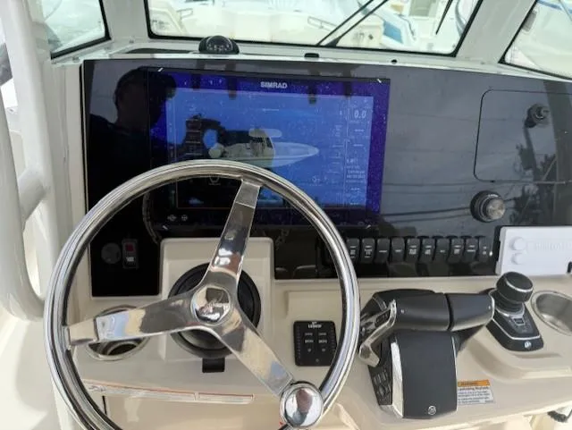 Slide: The Image of Control panel of 2023 Boston Whaler 280 Dauntless with steering wheel and navigation display. - 5