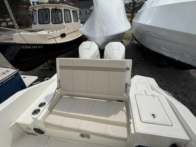 Slide: The Image of 2023 Boston Whaler 280 Dauntless boat interior with seating and covered engines. - 7