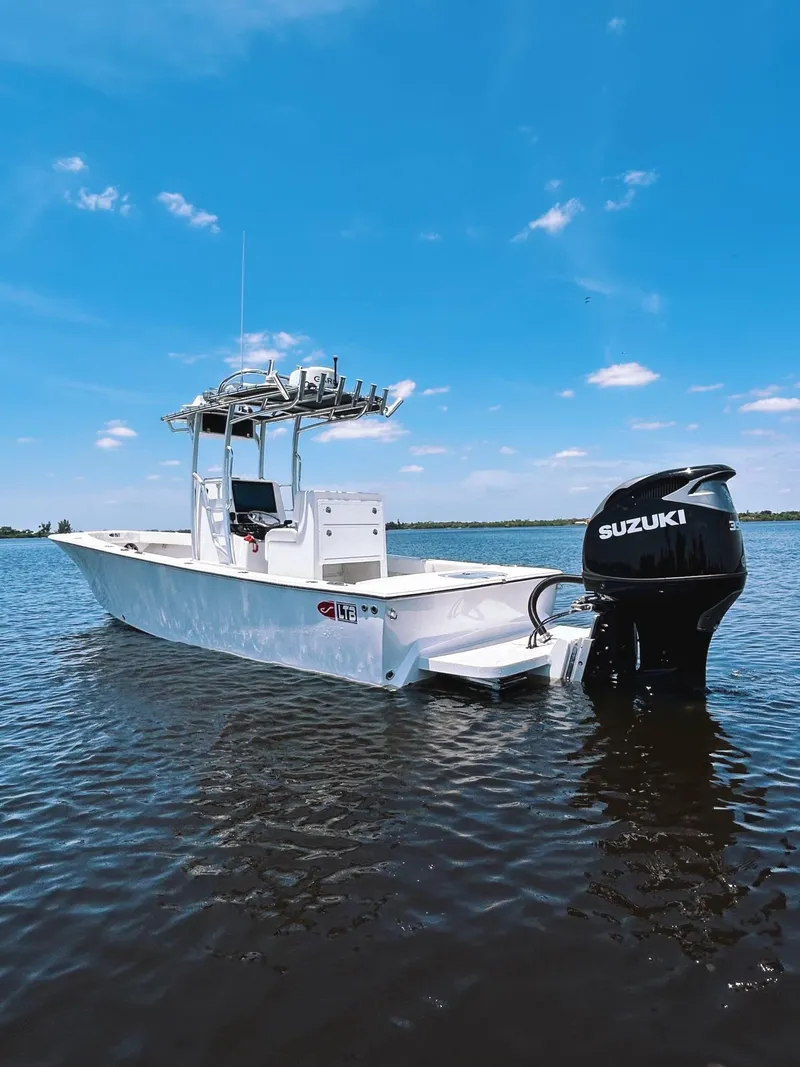Slide: The Image of 2024 Latitude Tournament Boats LTB 25 on water, featuring Suzuki outboard motor. - 1