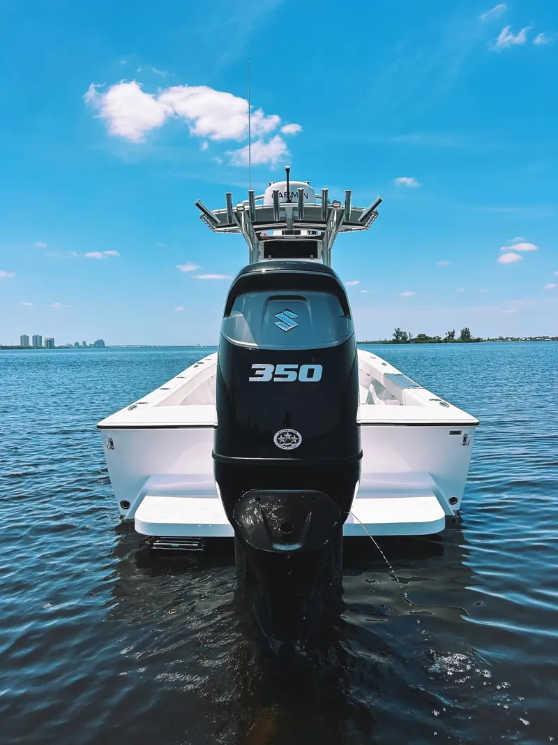 Slide: The Image of 2024 Latitude Tournament Boats LTB 25 with Suzuki 350 engine on calm water. - 2