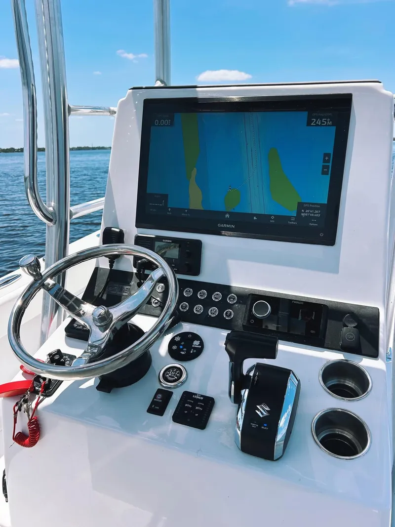 Slide: The Image of 2024 Latitude Tournament Boats LTB 25 helm with navigation display and controls. - 3