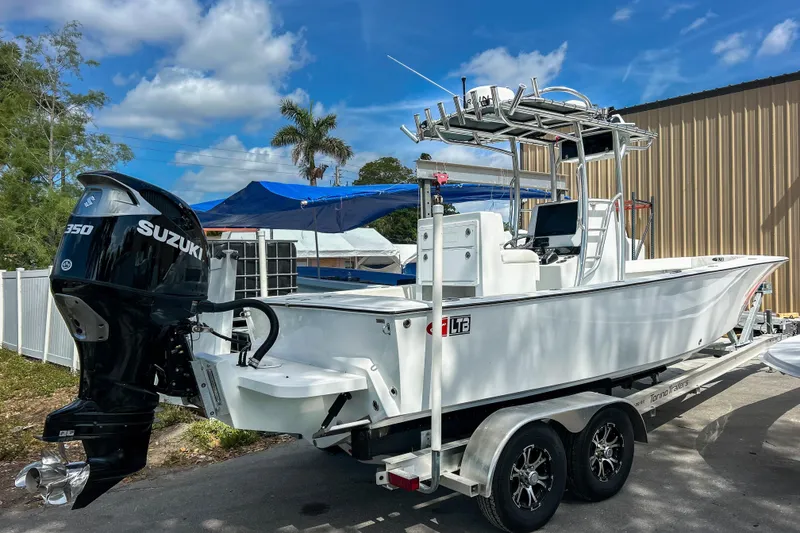 Slide: The Image of 2024 Latitude Tournament Boats LTB 25 on trailer, featuring Suzuki 250 outboard motor. - 4
