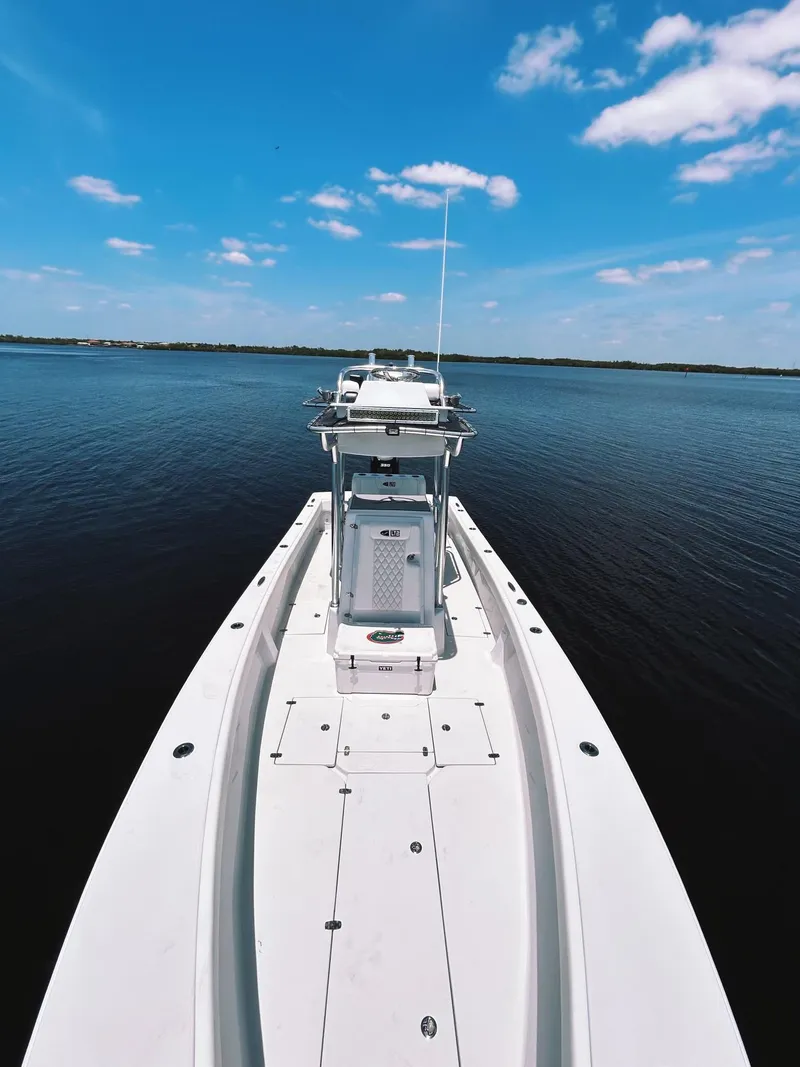 Slide: The Image of 2024 Latitude Tournament Boats LTB 25 on calm water under blue sky. - 5