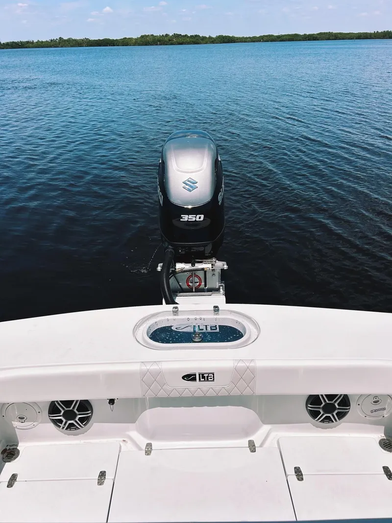 Slide: The Image of 2024 Latitude Tournament Boats LTB 25 with Suzuki 350 engine on calm water. - 6